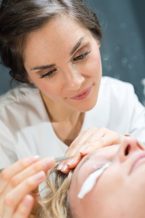 young woman enjoying facial massage at spa salon