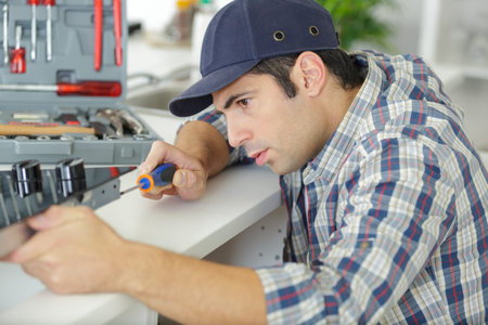 the man screws the bolt