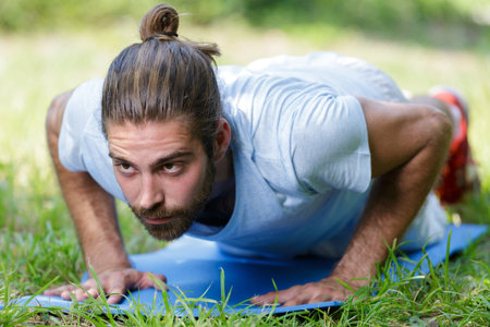 athlete exercising planks in forest