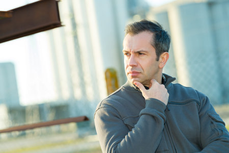 contemplative workman looking to the left