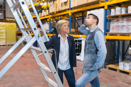 warehouse manager talking to colleague in a warehouse