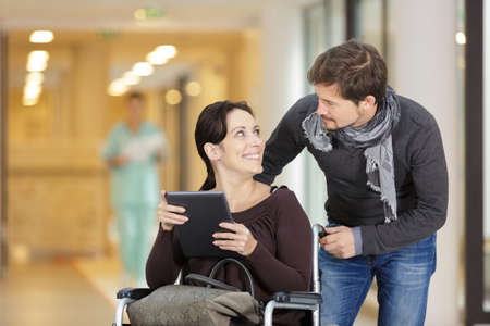 man comforting pregnant woman in corridor of hospitalの写真素材