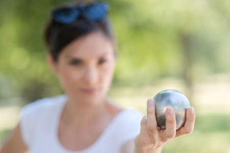 Hand of woman holding petanque ballの写真素材