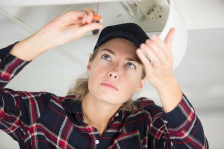 Woman fixing the kitchenの写真素材