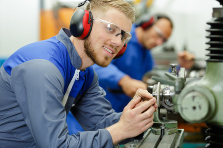 industrial worker inspecting work piece