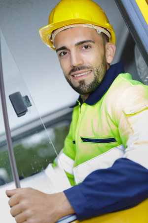 handsome man with his helmet and his safety vest