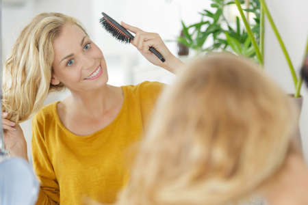 woman brushing hairの写真素材