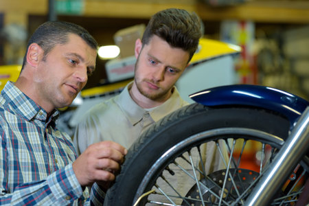 portrait of two motorcycle mechanics