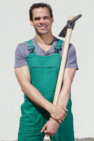 portrait of farmer holding hoe