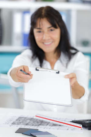 mature woman asking for signatureの写真素材