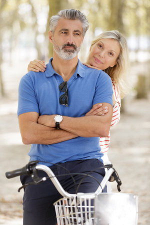 happy mature couple going for a bike rideの写真素材