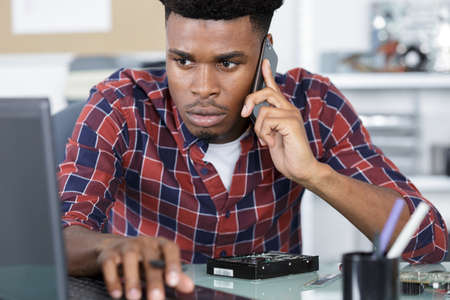 repairman on the phone checking tutorialの写真素材