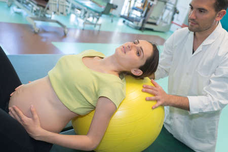 a pregnant woman and doctorの写真素材