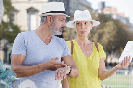 mature woman holding map man stressing the time restrictions