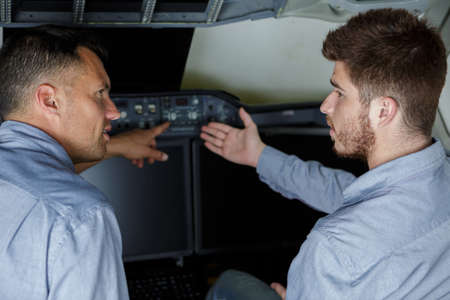 portrait of male aero engineers in an airplane cockpitの写真素材