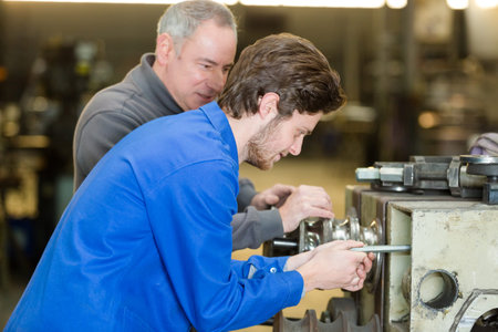 carpenter and apprentice in workshop