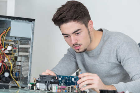 young handsome computer repairer concentrated on his work