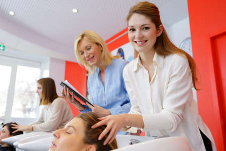 happy hair stylist at workの写真素材