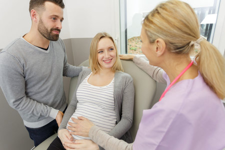doctor examining a pregnant woman in the hospitalの写真素材