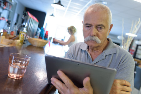 senior man using digital tablet