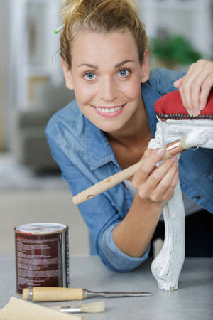 happy woman doing diy at homeの写真素材