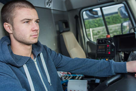 young man driving industrial vehicleの写真素材