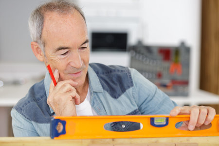 Senior man using spirit level