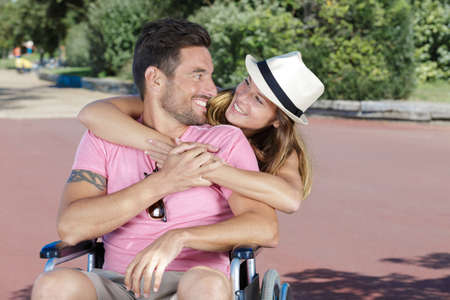 Man with woman in wheelchairの写真素材