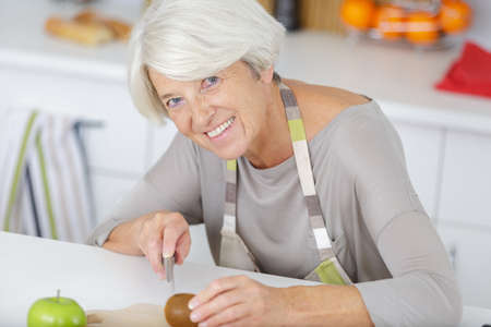 woman preparing salad in the kitchenの写真素材