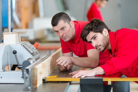 men cutting wood with a machine