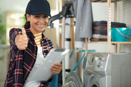 female appliance technician showing thumbs upの写真素材