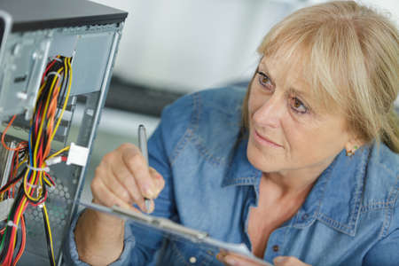 a computer maintenance woman with notesの写真素材