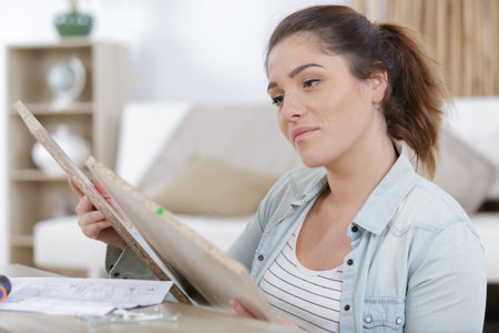 woman moving in assembly furniture at new home