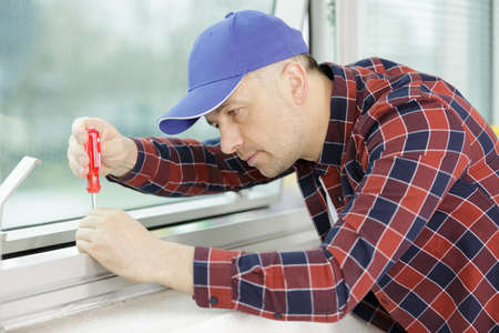 a repairman and the production of pvc windowsの写真素材