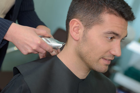man having his hair cut