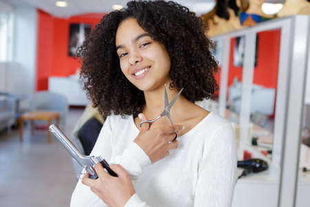 woman hairdresser with scissors in handの写真素材