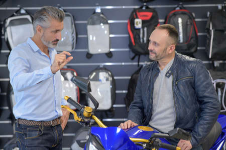 working at motorbike salonの写真素材