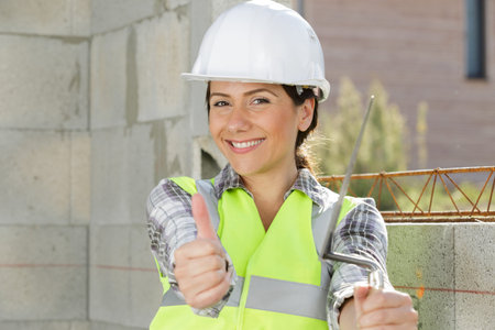 a cheerful female architect with thumbs up