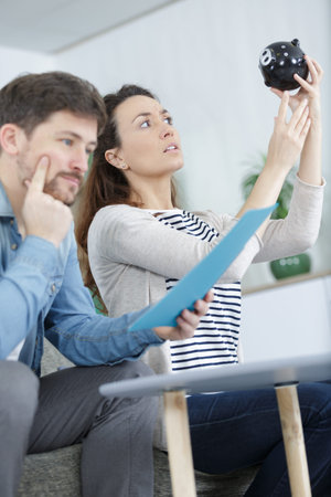 young couple thinking over pension plan at home