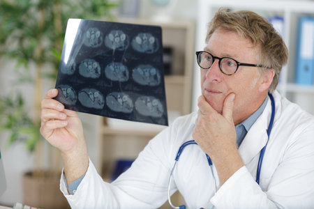 portrait senior doctor over radiography