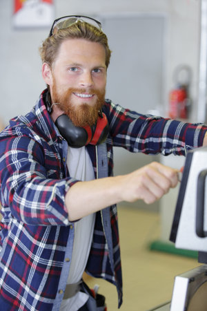 happy worker makes measurements of a metal profile