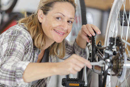 happy woman working with bikesの写真素材