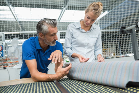 couple of fashion designers working in a textile factory