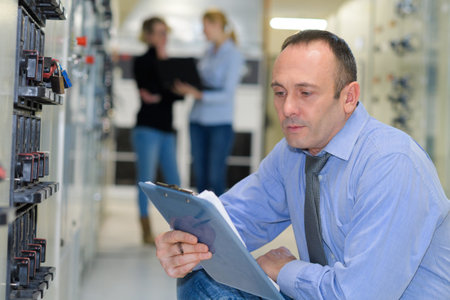 technician maintaining record of rack mounted server