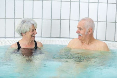 senior couple resting in hot tub in spa resortの写真素材