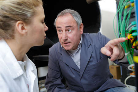 technical instructor teaching female studentの写真素材