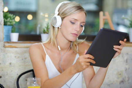 young gorgeous woman using a tablet in coffee shopの写真素材