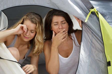 women waking up in a tentの写真素材