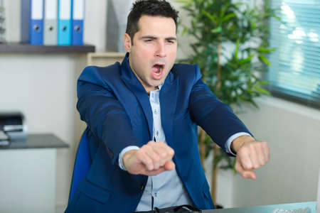 businessman yawning in the officeの写真素材