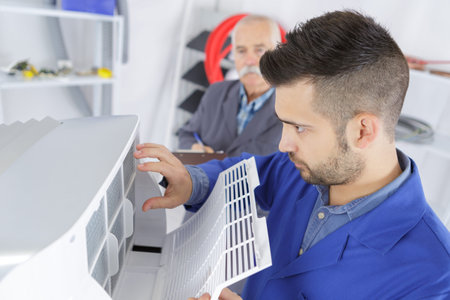 Worker opening plastic grill on appliance
